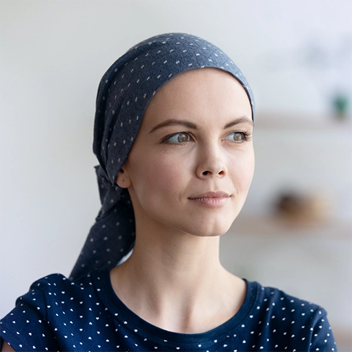 A young cancer patient in a matching scarf and shirt.